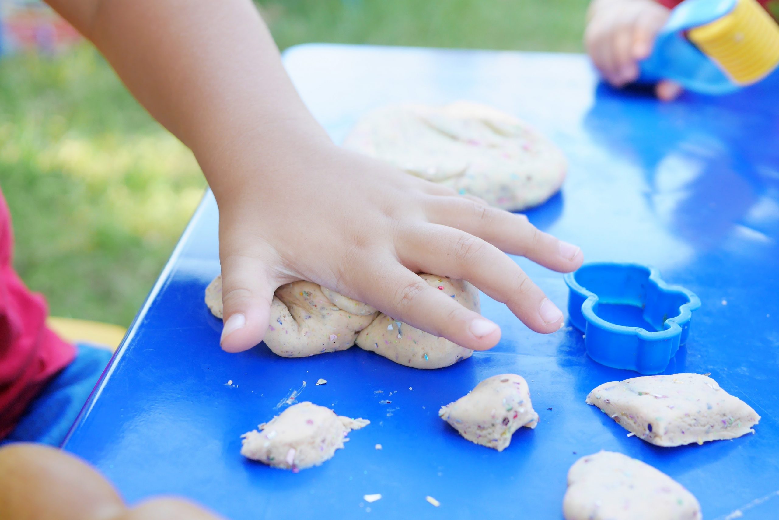photo-of-child-s-hand-playing-clay-2425817 copy